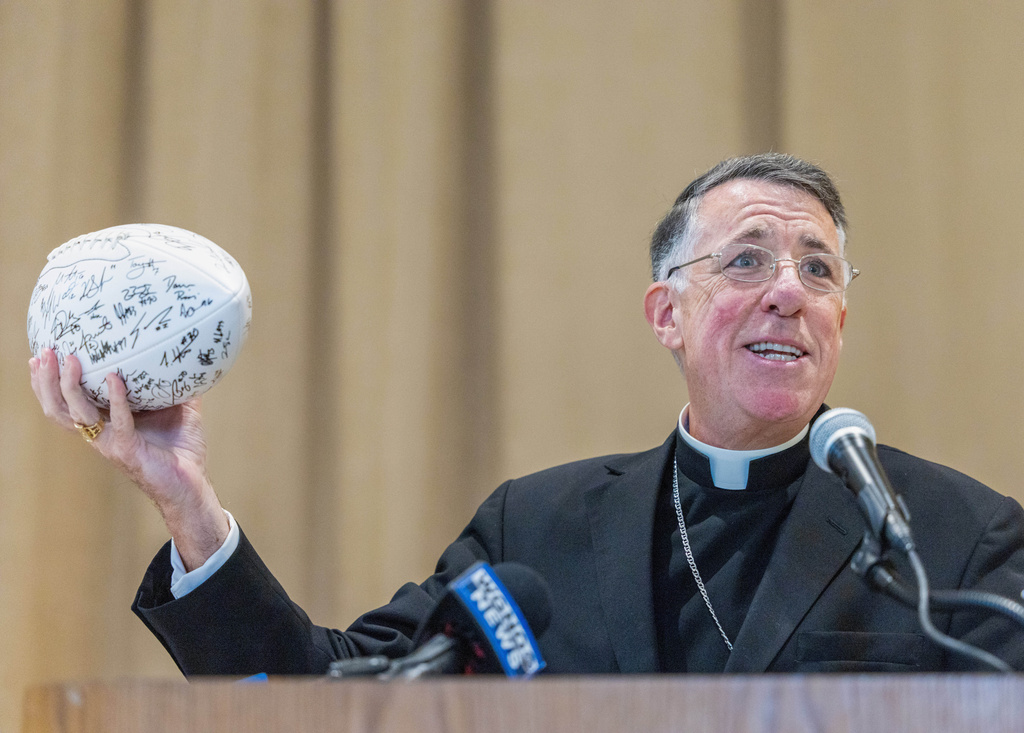 The Most Rev. Fr. James F. Checchio holds up an autographed New Orleans Saints football during his introduction to the city of New Orleans on Wednesday, Sept. 24, 2025, in New Orleans. (Chris Granger/The Times-Picayune/The New Orleans Advocate via AP)