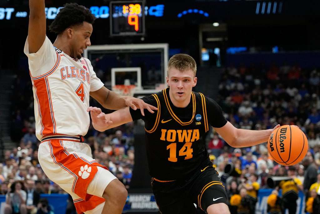 Iowa guard Bennett Stirtz (14) drives past Clemson guard Butta Johnson (4) during the first half in the first round of the NCAA college basketball tournament, Friday, March 20, 2026, in Tampa, Fla. (AP Photo/John Raoux)