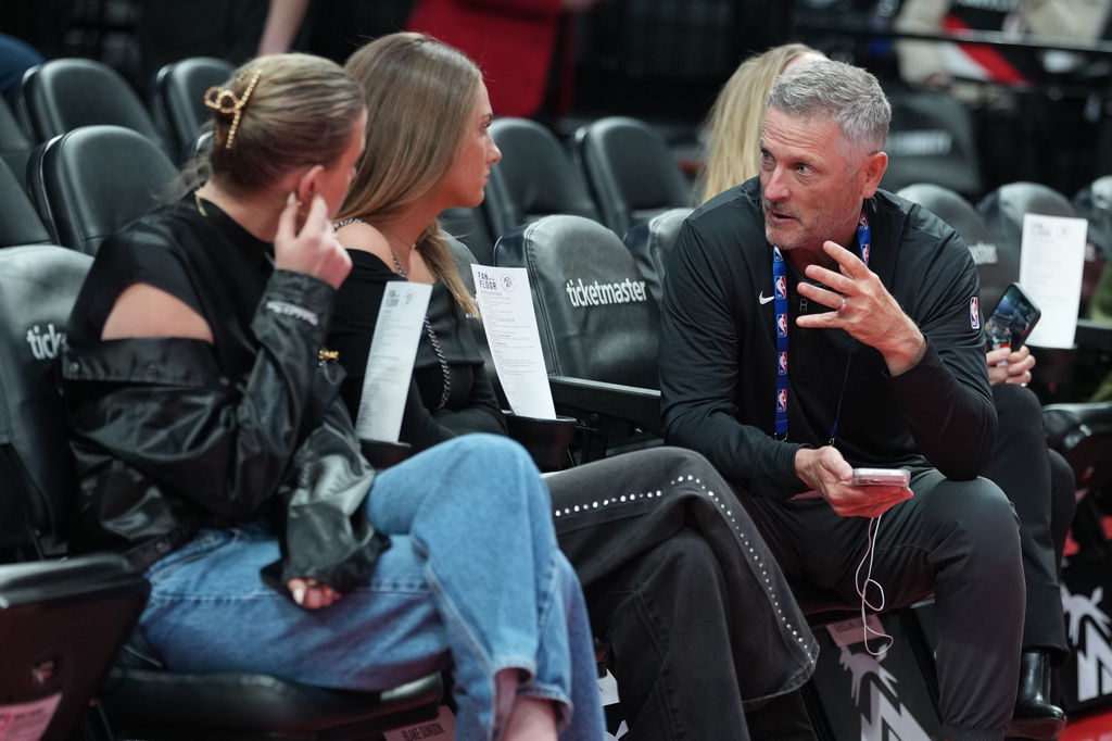 Portland Trail Blazers new owner Tom Dundon, right is seated before an NBA basketball game against the New Orleans Pelicans, Thursday, April 2, 2026, in Portland, Ore. (AP Photo/Jenny Kane)
