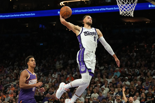Sacramento Kings guard Zach LaVine (8) dunks over Phoenix Suns forward Oso Ighodaro during the first half of an NBA basketball game, Wednesday, Oct. 22, 2025, in Phoenix. (AP Photo/Rick Scuteri) Sacramento Kings guard Zach LaVine (8) dunks over Phoenix Suns forward Oso Ighodaro during the first half of an NBA basketball game, Wednesday, Oct. 22, 2025, in Phoenix. (AP Photo/Rick Scuteri)