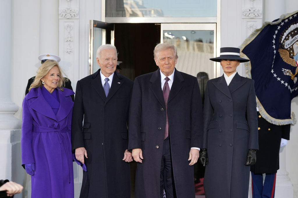 FILE - President-elect Donald Trump and Melania Trump are greeted by President Joe Biden and first lady Jill Biden, upon their arrival at the White House, Jan. 20, 2025, in Washington. (AP Photo/Alex Brandon, File)