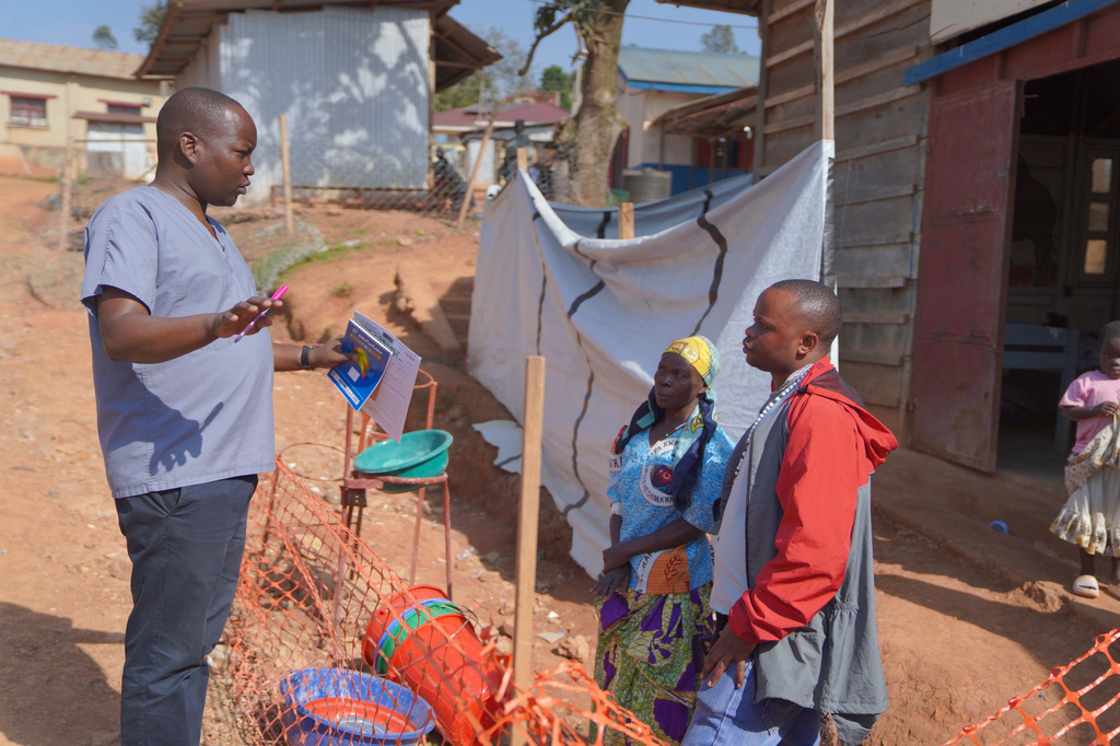 Gédéon Banga Ngbape, left, an Ebola surveillance officer, does contact tracing in Nizi, Ituri province, eastern Congo, Friday, Aug. 14, 2026. (AP Photo/Dieudonne Dirole)