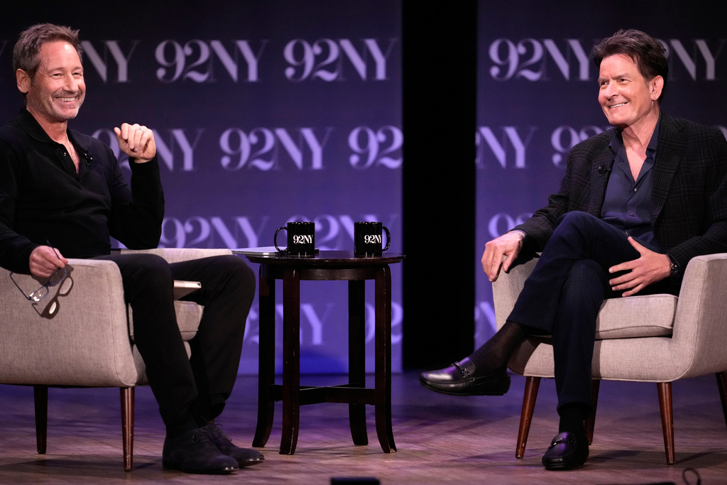 David Duchovny, left, and Charlie Sheen discuss the book "The Book of Sheen" at the 92nd Street Y on Monday, Sept. 8, 2025, in New York. (Photo by Charles Sykes/Invision/AP)