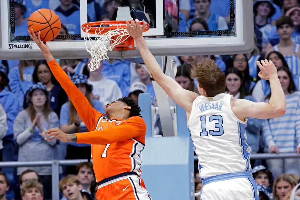 Syracuse forward Kiyan Anthony, left, drives against North Carolina center Henri Veesaar (13) during the first half of an NCAA college basketball game Monday, Feb. 2, 2026, in Chapel Hill, N.C. (AP Photo/Chris Seward)