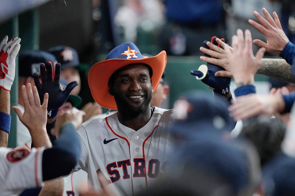 Houston Astros designated hitter Yordan Alvarez is congratulated in the dugout after hitting a solo home run during the third inning of a baseball game against the Colorado Rockies, Wednesday, April 15, 2026, in Houston. (AP Photo/Kevin M. Cox)