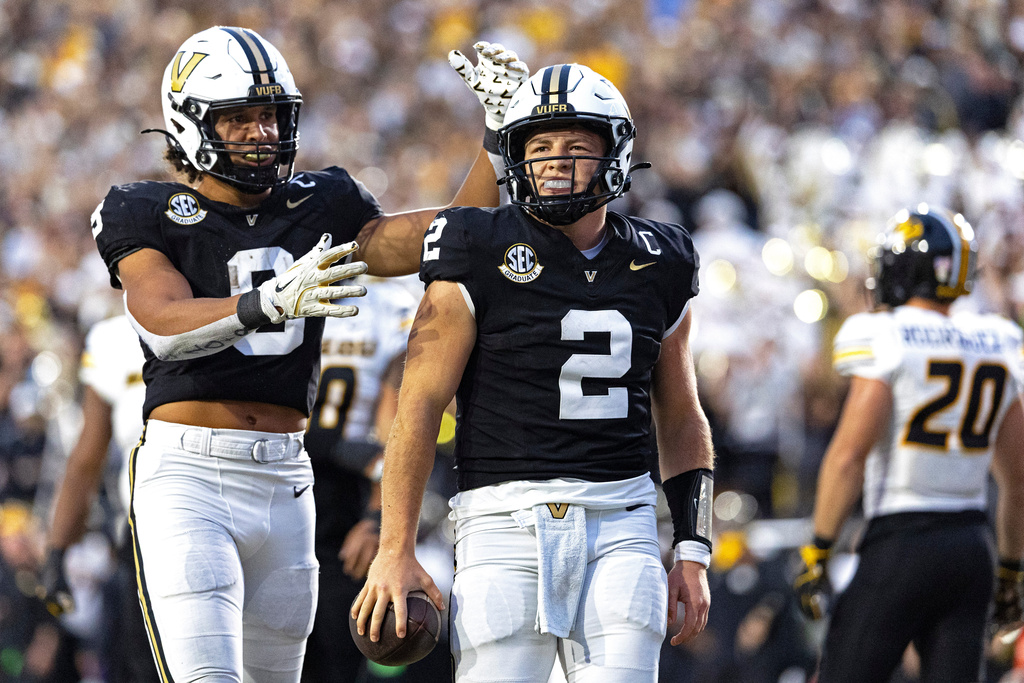 Vanderbilt quarterback Diego Pavia (2) celebrates with tight end Eli Stowers after scoring a touchdown during the second half of an NCAA college football game against Missouri, Saturday, Oct. 25, 2025, in Nashville, Tenn. (AP Photo/Wade Payne)