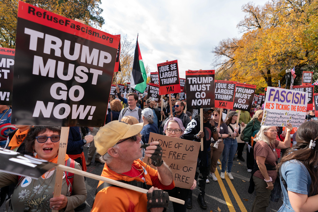 Demonstrators march towards the U.S. Capitol during Trump Must Go Now rally on the National Mall in Washington, Wednesday, Nov. 5, 2025. (AP Photo/Jose Luis Magana)