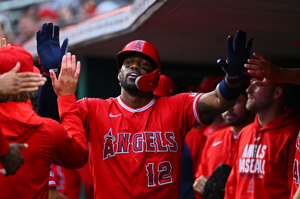 Los Angeles Angels' Jorge Soler (12) celebrates with teammates after earning a run during the third inning of a baseball game against the Cincinnati Reds in Cincinnati, Friday, April 10, 2026. (AP Photo/Ben Jackson)
