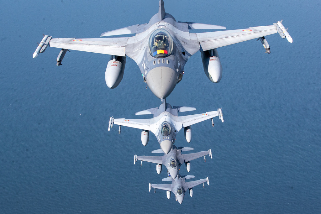 FILE - A Romanian Air Force F-16 military fighter jet, front, and Portuguese Air Force F-16s participating in NATO's Baltic Air Policing Mission operate over the Baltic Sea, Lithuanian airspace, on May 22, 2023. (AP Photo/Mindaugas Kulbis, File)