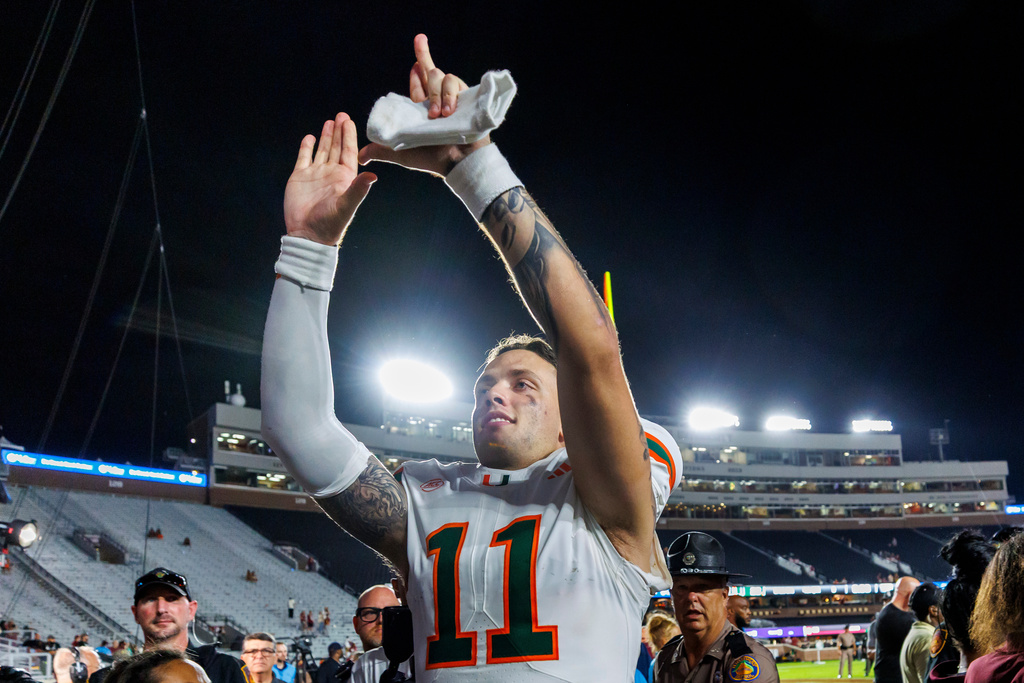 Miami quarterback Carson Beck (11) celebrates after defeating Florida State in a NCAA college football game, Saturday, Oct. 4, 2025, in Tallahassee, Fla. (AP Photo/Colin Hackley)