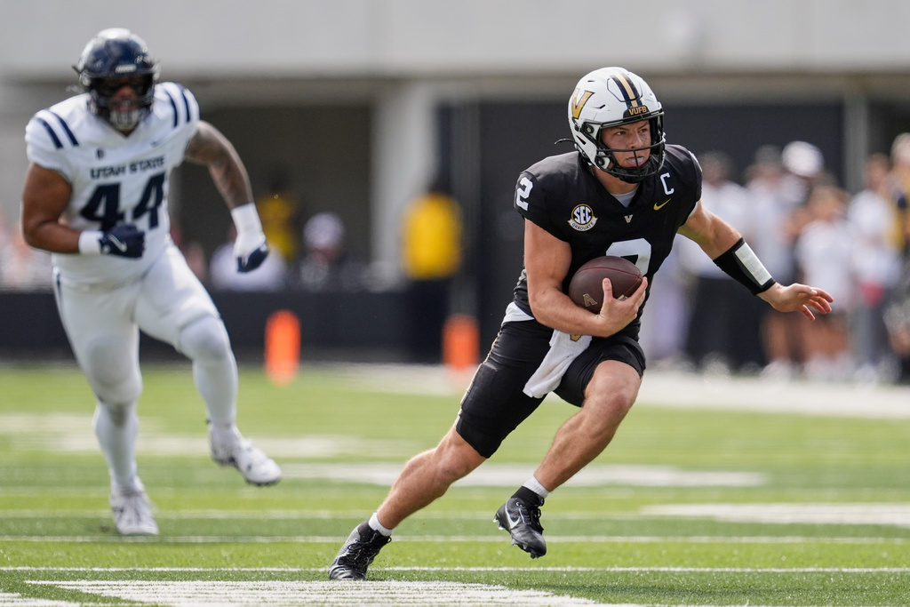 Vanderbilt quarterback Diego Pavia (2) runs for a first down during the first half of an NCAA college football game against Utah State, Saturday, Sept. 27, 2025, in Nashville, Tenn. (AP Photo/George Walker IV)