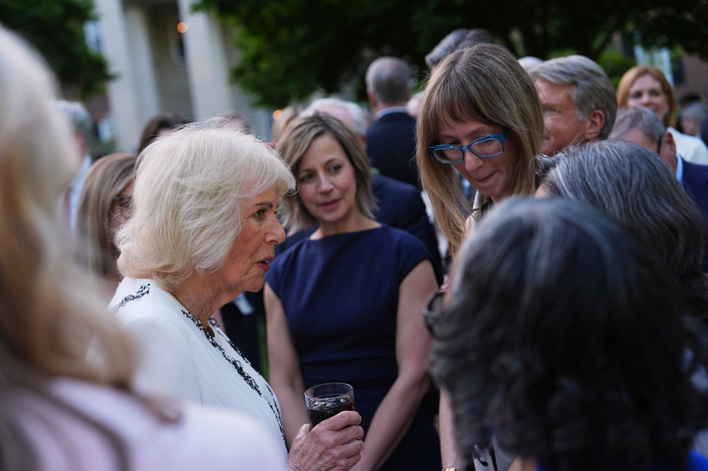 Queen Camilla greets guests during a garden party at the British Embassy, Monday, April 27, 2026, in Washington. (AP Photo/Julia Demaree Nikhinson, Pool)