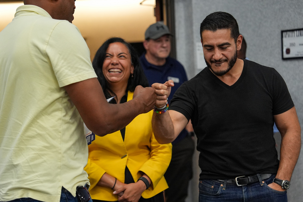 Abdul El-Sayed, right, a progressive candidate in the Democratic primary for U.S. Senate in Michigan, accompanied by Rep. Analilia Mejia, D-N.J., greets a supporter during a campaign rally at the UAW Region 1 Union Hall, Sunday, Aug. 2, 2026, in Warren, Mich. (AP Photo/Julia Demaree Nikhinson)