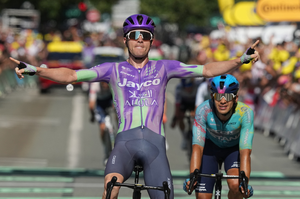 Switzerland's Mauro Schmid celebrates as he crosses the finish line ahead of Colombia's Harold Tejada, right, to win the thirteenth stage of the Tour de France cycling race with start in Dole and finish in Belfort, France, Friday, July 17, 2026. (AP Photo/Thibault Camus)