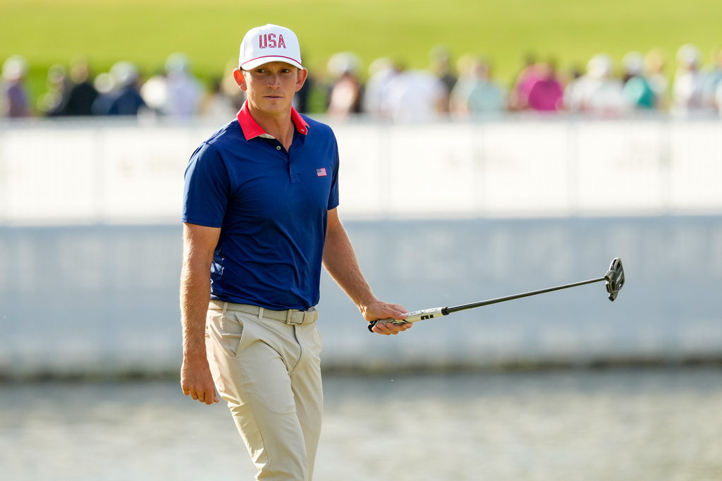 USA teams' Jacob Bridgeman watches his shot on the 13th green against the International team during a Presidents Cup golf tournament third round foursome match at Medinah Country Club, Saturday, Sept. 26, 2026, in Medinah, Ill. (AP Photo/Chris Carlson)