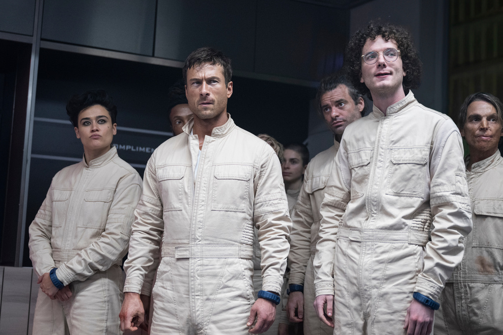 This image released by Paramount Pictures shows, foreground from left, Katy O'Brian, Glen Powell and Martin Herlihy in a scene from "The Running Man." (Ross Ferguson/Paramount Pictures via AP)