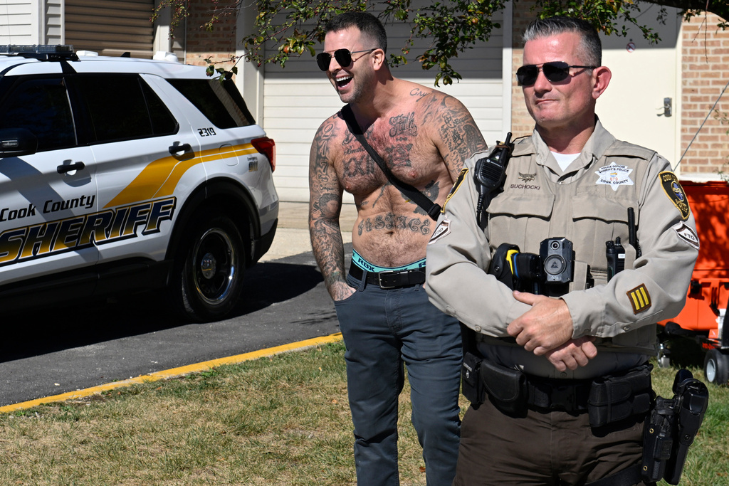 A counter protestor yells behind a Cook County Sheriff at demonstrators against ICE outside an immigration processing facility in Broadview, Ill., Thursday, Oct. 9, 2025. (AP Photo/Paul Beaty)
