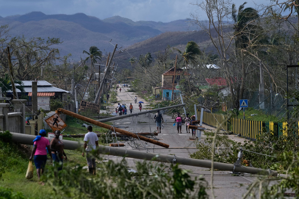 Residents walk through Lacovia Tombstone, Jamaica, in the aftermath of Hurricane Melissa, Wednesday, Oct. 29, 2025. (AP Photo/Matias Delacroix)