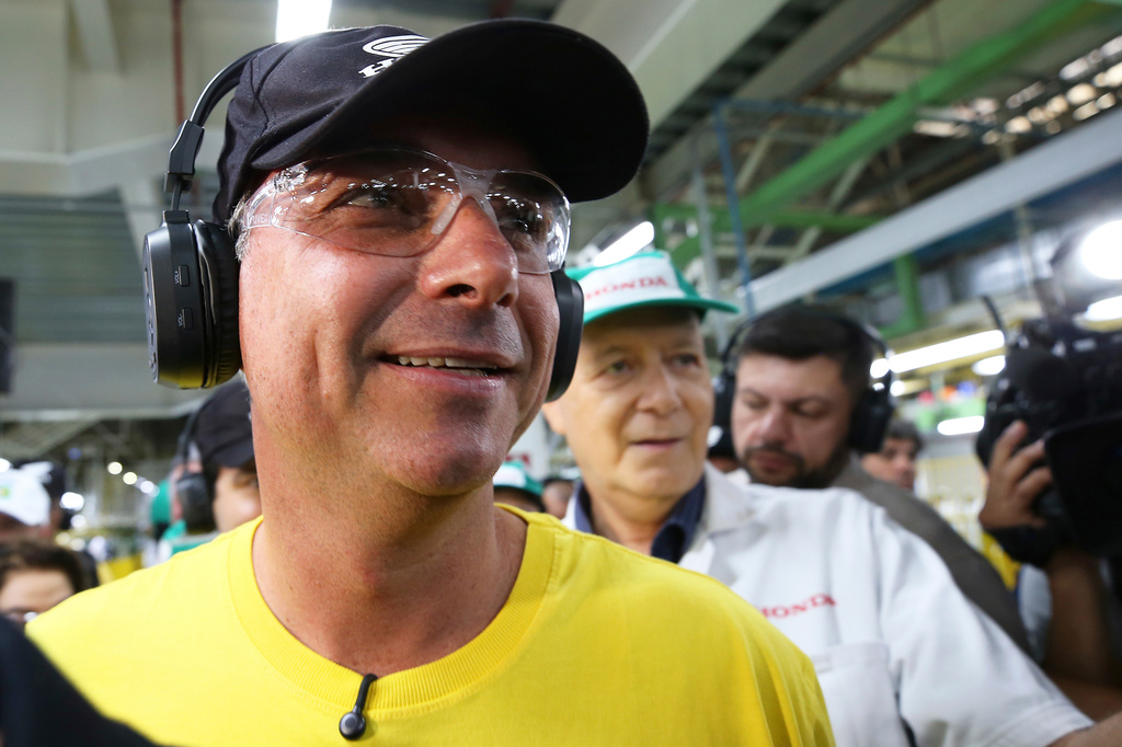Opposition presidential candidate Sen. Flavio Bolsonaro wears protective glasses and headphones during a visit to a Honda motorcycle factory in the Manaus Free Trade Zone during a campaign event in Manaus, Amazonas state, Brazil, Friday, Sept. 11, 2026. (AP Photo/Edmar Barros)