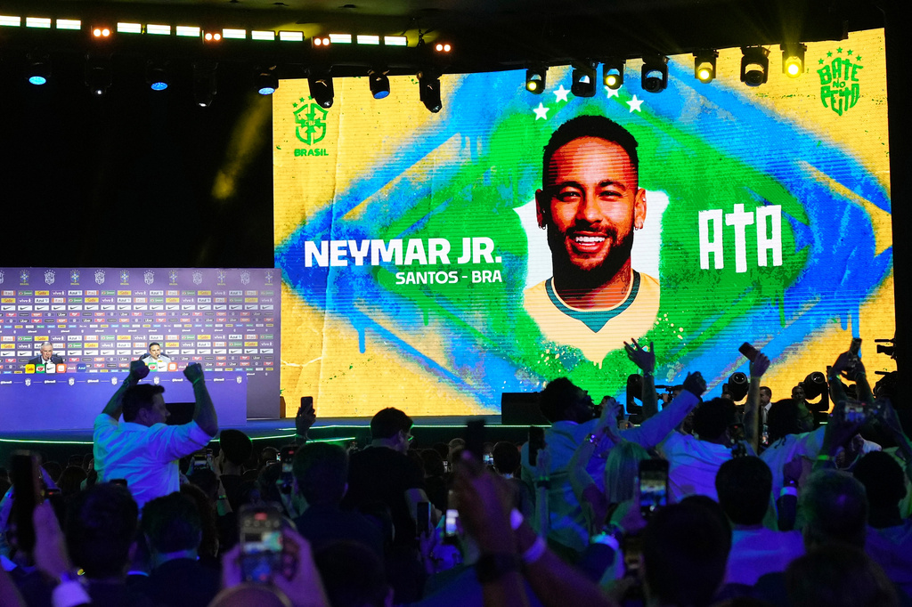 A screen displays an image of Neymar after coach Carlo Ancelotti, left, included him in Brazil's squad for the 2026 FIFA World Cup in Rio de Janeiro, Monday, May 18, 2026. (AP Photo/Silvia Izquierdo)
