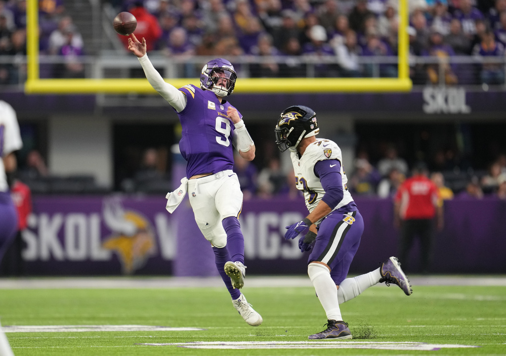 Minnesota Vikings quarterback J.J. McCarthy (9) throws under pressure from Baltimore Ravens linebacker Kyle Van Noy in the second half of an NFL football game, Sunday, Nov. 9, 2025, in Minneapolis. (AP Photo/Abbie Parr)