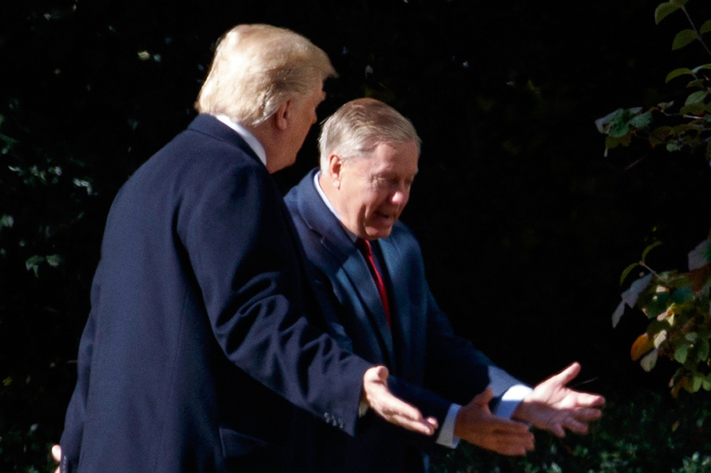 FILE - President Donald Trump walks to the Oval Office with Sen. Lindsey Graham, R-S.C., Thursday, Nov. 8, 2018, in Washington. (AP Photo/Evan Vucci, File)