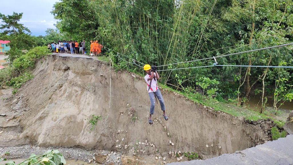 A person is evacuated with the help of a temporary zip line laid by the National Disaster Response Force (NDRF) following multiple landslides triggered by torrential rains near Jalpaiguri in the Indian state of West Bengal, Sunday, Oct. 5, 2025. (The National Disaster Response Force vis AP)