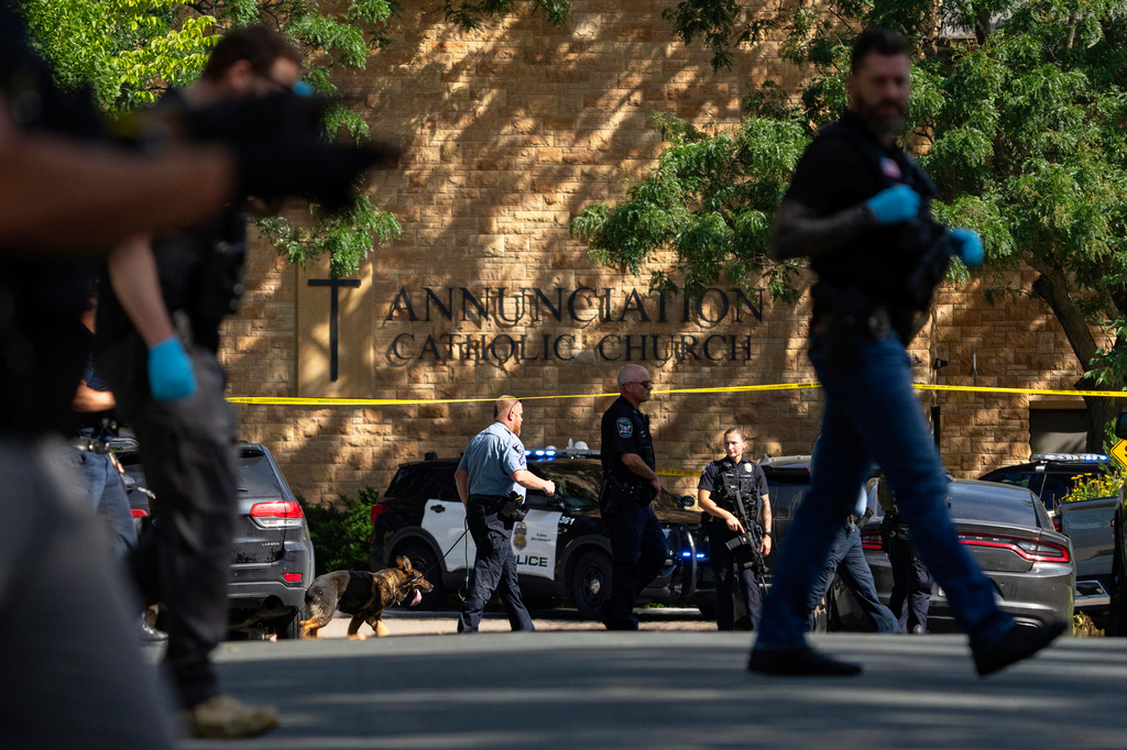 FILE - Law enforcement officers search the nearby neighborhood to clear the area after a shooting at Annunciation Catholic Church in Minneapolis, Aug. 27, 2025. (Alex Kormann/Star Tribune via AP, File)