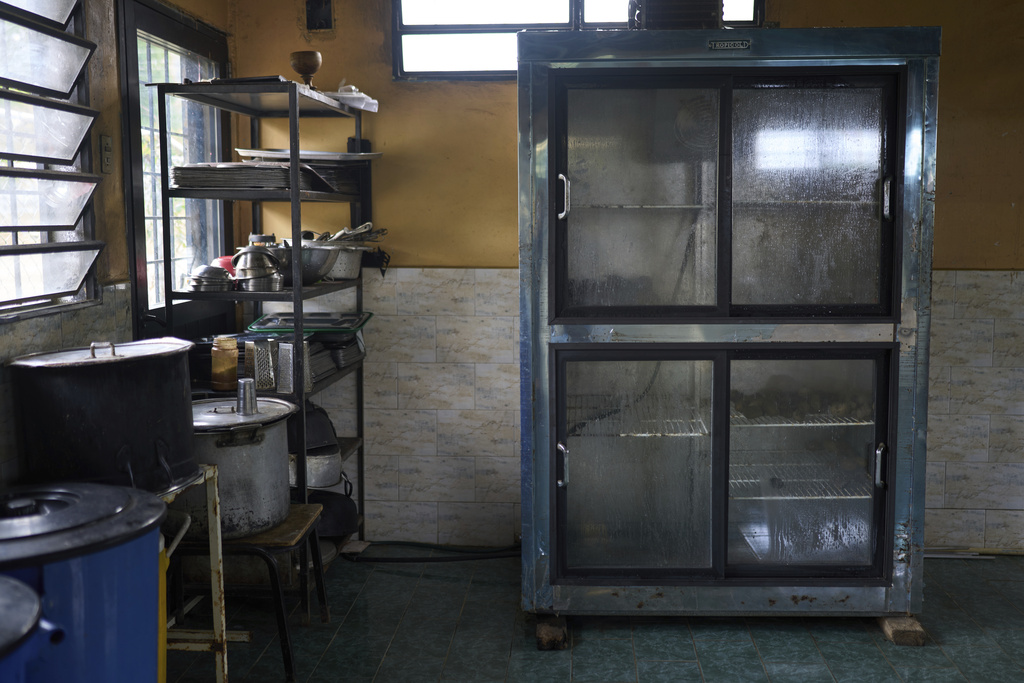 A refrigerator stands empty inside a school kitchen in La Sierra, Venezuela, Thursday, June 26, 2025. (AP Photo/Ariana Cubillos)
