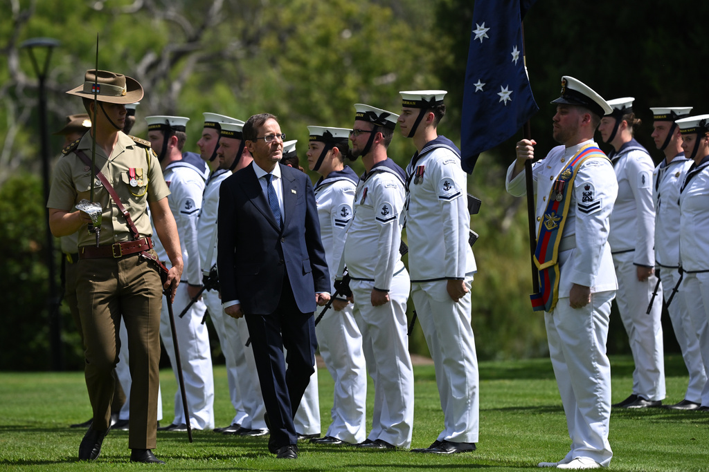 Israeli President Isaac Herzog, second left, inspects a guard of honor during a ceremonial welcome at Government House in Canberra, Australia, Wednesday, Feb. 11, 2026. (Lukas Coch/AAP Image via AP)