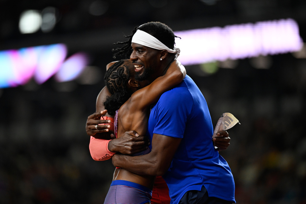 Melissa Jefferson-Wooden, of the United States, and Kenneth Bednarek, of the United States, right, hug each other after winning the women's 200 meters final and the men's 200 meters final, respectively, during the World Athletics Ultimate Championship in Budapest, Hungary, Sunday, Sept. 13, 2026. (AP Photo/Denes Erdos)