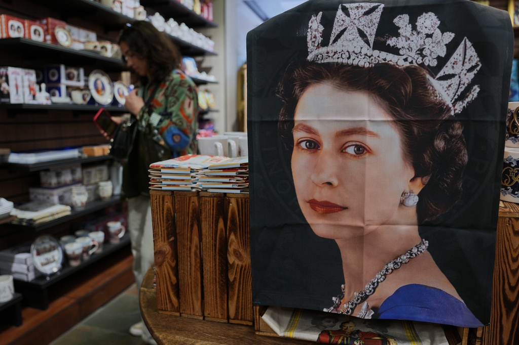 Tea towel with photo of late Queen Elizabeth II is on display for sale at a souvenirs shop in London, on April 17, 2026. (AP Photo/Kin Cheung)