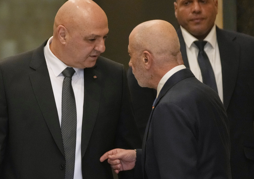 Lebanese President Joseph Aoun, left, speaks with one of his advisors, as he arrives to lead a cabinet meeting, at the Presidential palace in Baabda, east of Beirut, Friday, Sept. 5, 2025. (AP Photo/Hussein Malla)