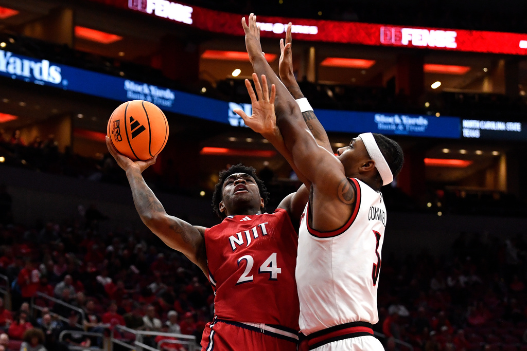 NJIT guard Ari Fulton (24) shoots over Louisville guard Ryan Conwell (3) during the first half of an NCAA college basketball game in Louisville, Ky., Wednesday, Nov. 26, 2025. (AP Photo/Timothy D. Easley)