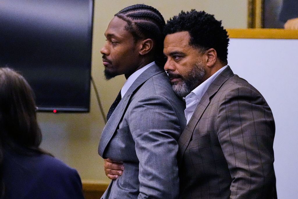 Former New England Patriots wide receiver Stefon Diggs, left, is embraced after a not guilty verdict at his trial at Norfolk County District Court, Tuesday, May 5, 2026, in Dedham, Mass. (AP Photo/Charles Krupa, Pool)