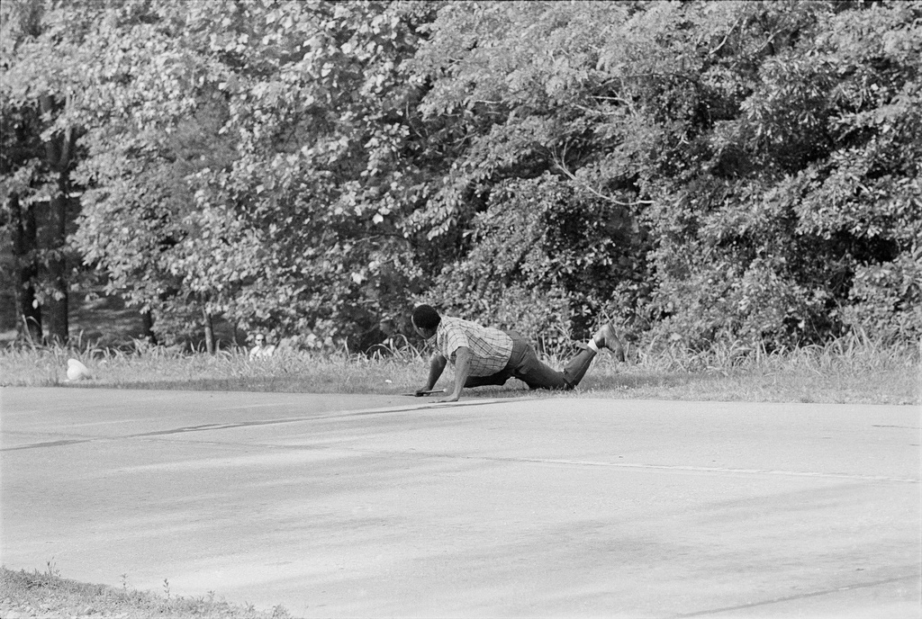 FILE - James Meredith looks at Aubrey James Norvell, background left partially hidden behind foliage, after being shot on a road near Hernando, Miss., June 6, 1966. (AP Photo/Jack Thornell, File)