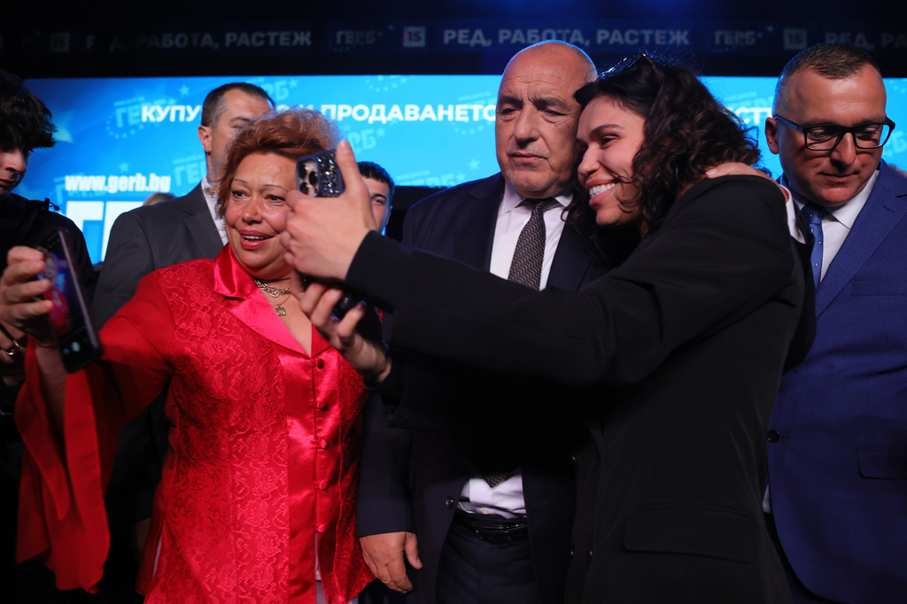 Former three-time conservative Prime Minister Boyko Borissov poses for selfies with supporters at the closing rally of his campaign, in Samokov, Wednesday, April 15, 2026, as Bulgaria heads into an early parliamentary election. (AP Photo/Valentina Petrova)
