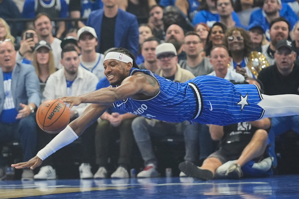 Orlando Magic center Wendell Carter Jr. dives for a loose ball during the first half in Game 4 of a first-round NBA basketball playoff series against the Detroit Pistons, Monday, April 27, 2026, in Orlando, Fla. (AP Photo/John Raoux)
