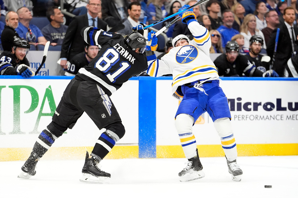 Tampa Bay Lightning defenseman Erik Cernak (81) hits Buffalo Sabres left wing Jason Zucker up high during the first period of an NHL hockey game Saturday, Feb. 28, 2026, in Tampa, Fla. (AP Photo/Chris O'Meara)