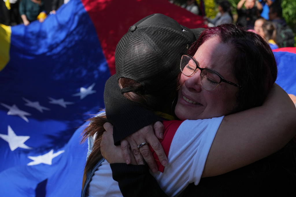 Supporters of Venezuela's opposition embrace as they celebrate in Mexico City, Sunday, Jan. 4, 2026, a day after U.S. forces captured President Nicolas Maduro and flew him to the United States. (AP Photo/Marco Ugarte)