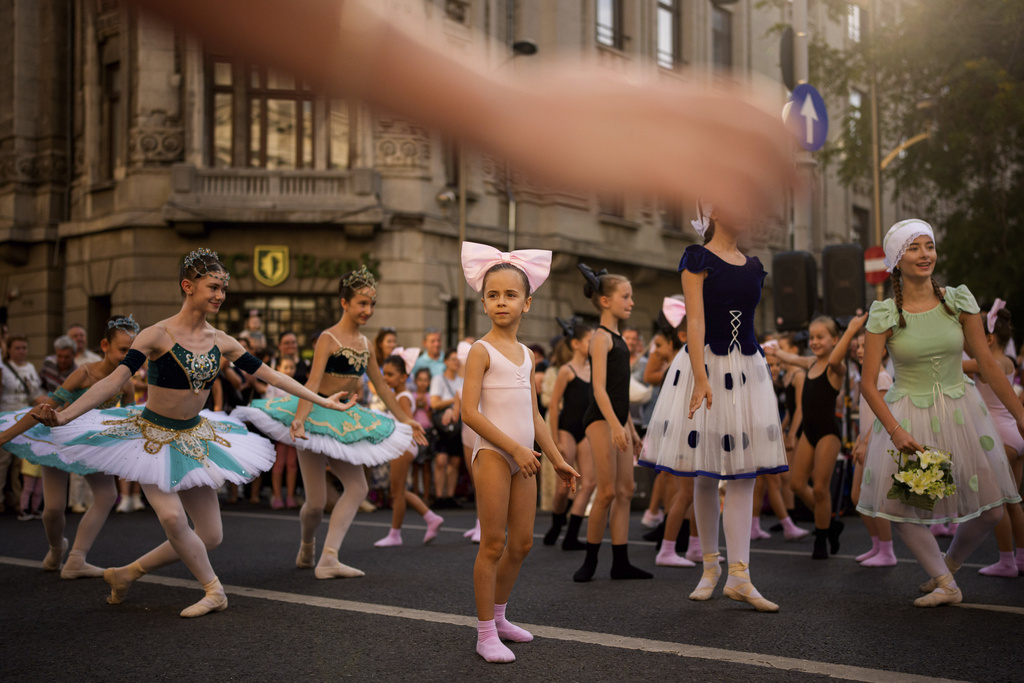 Children of the Romanian National Opera's Ballet Studio outside the National History Museum of Romania during Dance Night, an event featuring a wide variety of dance styles performed on the Calea Victoriei avenue in Bucharest, Romania, Saturday, Aug. 23, 2025. (AP Photo/Andreea Alexandru)
