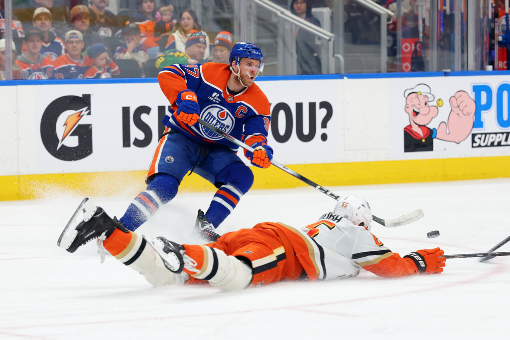 Anaheim Ducks' Jacob Trouba (65) slides in front of Edmonton Oilers' Connor McDavid (97) during the second period of an NHL hockey game in Edmonton, Alberta, Saturday March 28, 2026. (James Maclennan/The Canadian Press via AP)