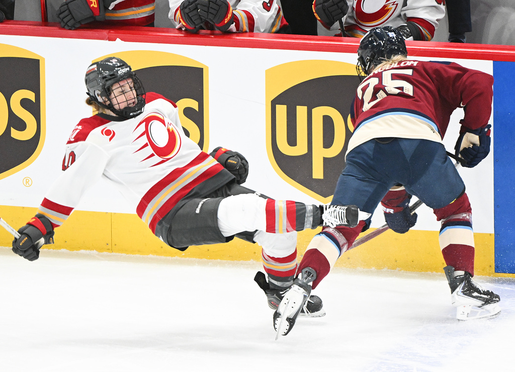 Ottawa Charge's Alexa Vasko (10) is checked by Montreal Victoire's Lina Ljungblom (25) during first period PWHL hockey action in Laval, Que., Tuesday, Jan. 13, 2026. (Graham Hughes/The Canadian Press via AP)