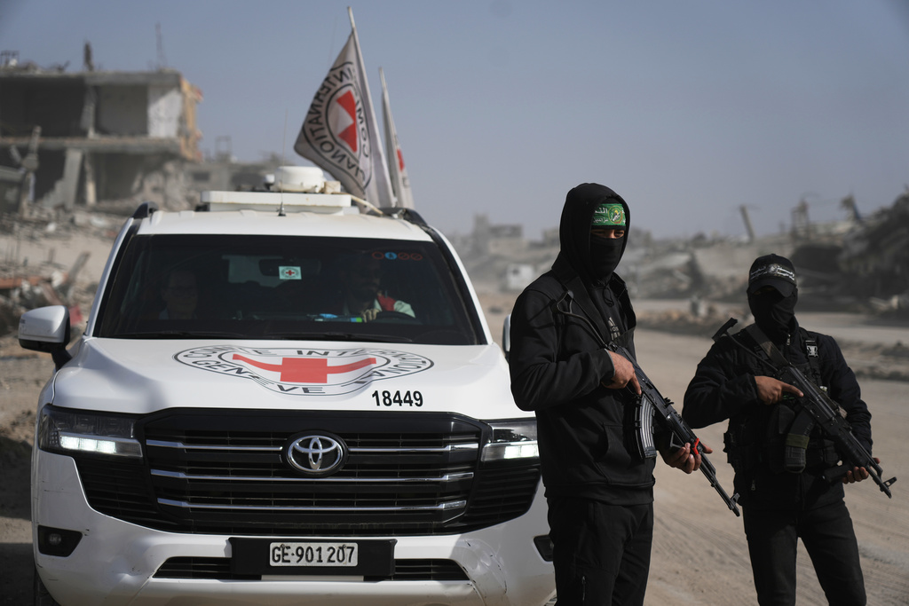 FILE - Hamas militants accompanied by members of the International Committee of the Red Cross (ICRC) head to Zeitoun neighborhood of Gaza City to search for the remains of the final hostage, Dec. 8, 2025. (AP Photo/Jehad Alshrafi, File)
