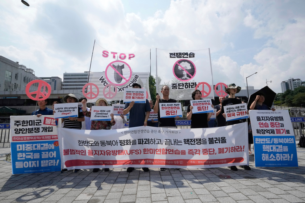 South Korean protesters stage a rally to oppose the joint military exercises, Ulchi Freedom Shield or UFS, between the U.S. and South Korea in front of the presidential office in Seoul, South Korea, Monday, Aug. 18, 2025. The banners read "Stop the military exercise between the U.S. and South Korea." (AP Photo/Ahn Young-joon)
