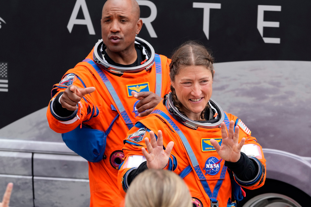 Astronauts, Mission Specialist Christina Koch, right, and Pilot Victor Glover wave to family members as they leave the Operations and Checkout Building for a trip to Launch Pad 39-B and a planned liftoff on NASA's Artermis II moon rocket at the Kennedy Space Center Wednesday, April 1, 2026, in Cape Canaveral, Fla. (AP Photo/Chris O'Meara)