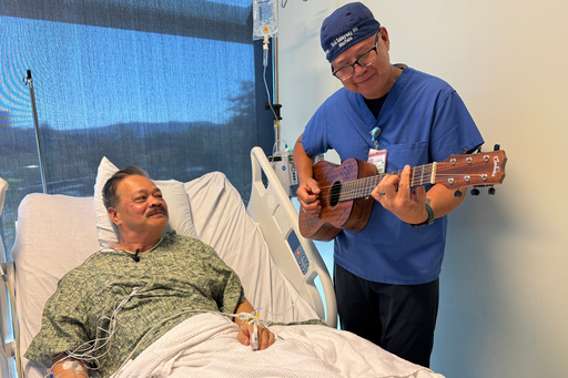 Nurse Rod Salaysay plays guitar for patient Richard Hoang in the recovery unit of UC San Diego Health in San Diego, Calif., on Sept. 30, 2025. (AP Photo/Javier Arciga) Nurse Rod Salaysay plays guitar for patient Richard Hoang in the recovery unit of UC San Diego Health in San Diego, Calif., on Sept. 30, 2025. (AP Photo/Javier Arciga)