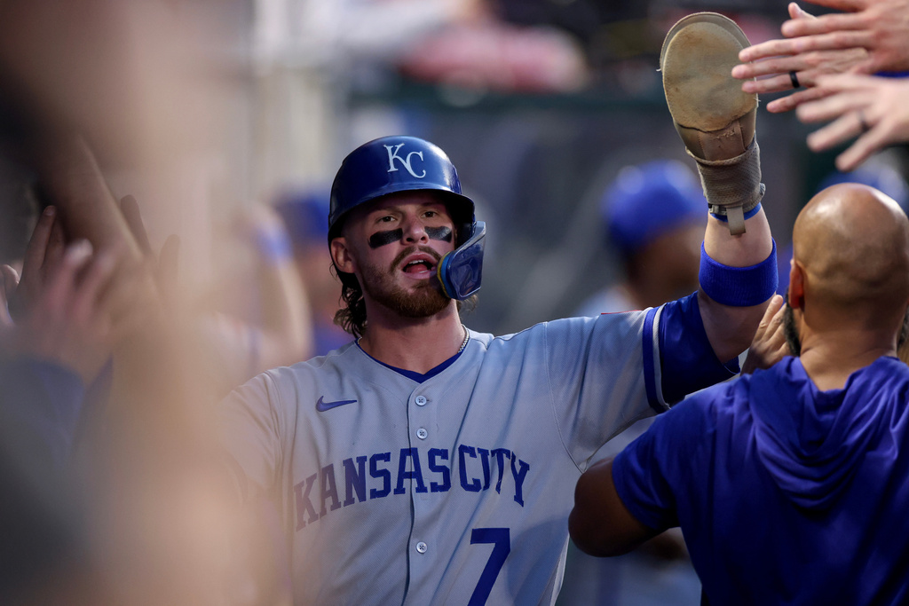 Kansas City Royals' Bobby Witt Jr. (7) high fives teammates after scoring a run during the first inning of a baseball game against the Los Angeles Angels Tuesday, Sept. 23, 2025, in Anaheim, Calif. (AP Photo/Eric Thayer)