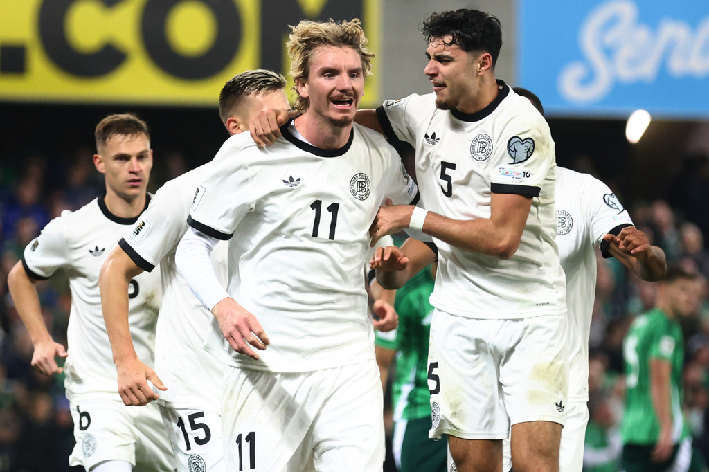 FILE - Germany's Nick Woltemade, left, celebrates after scoring the opening goal of his team during the World Cup 2026 group A qualifying soccer match between Northern Ireland and Germany at Windsor Park stadium, in Belfast, Northern Ireland, Monday, Oct. 13, 2025. (AP Photo/Peter Morrison, File)