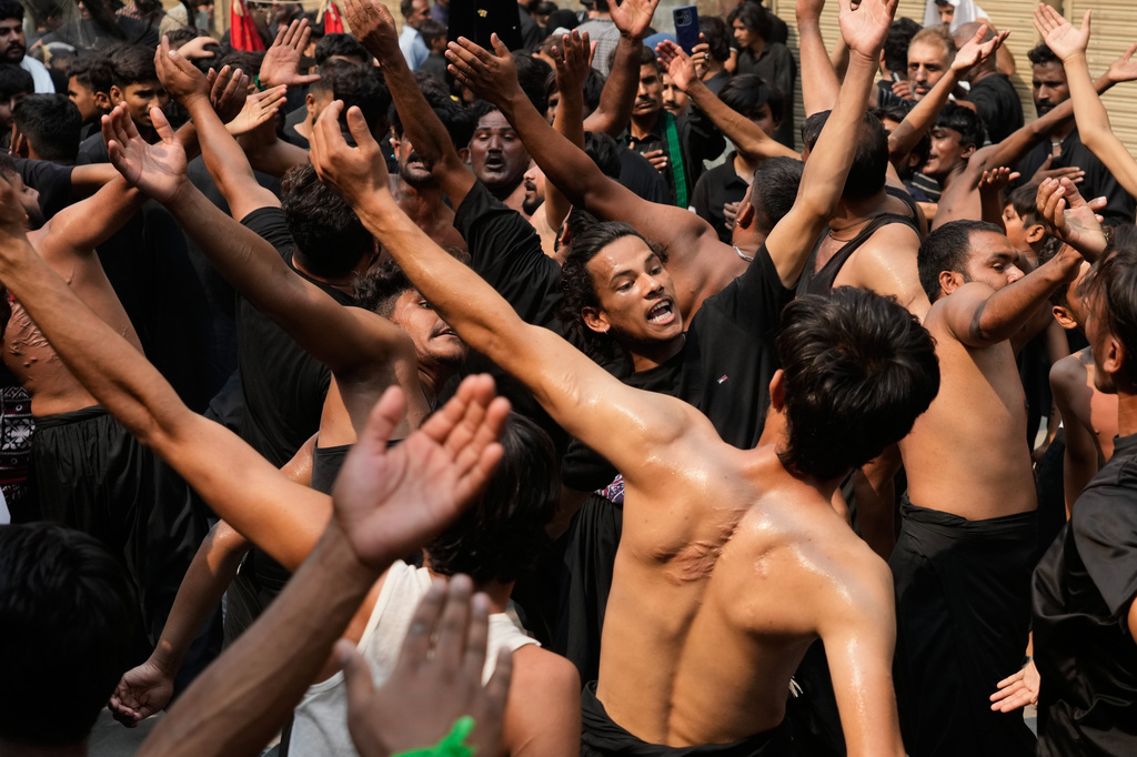 Shiite Muslims beat their chests in a ritual during a gathering in the mourning month of Muharram, in Lahore, Pakistan, Wednesday, Jun 24, 2026. (AP Photo/K.M. Chaudary)